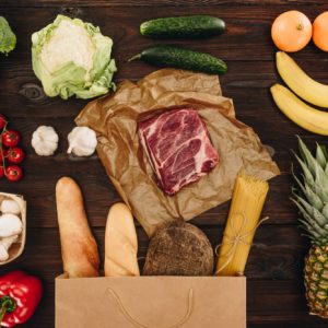 top view of raw meat with vegetables and fruits on wooden table, grocery concept